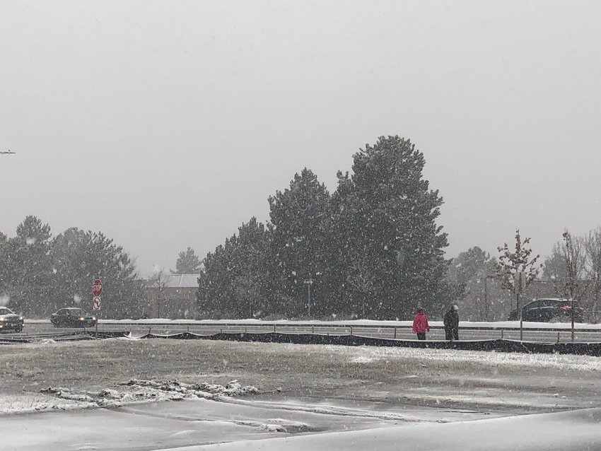 A few intrepid pedestrians made their way down South Broadway in Littleton this morning ahead of the "Bomb Cyclone" snowstorm.